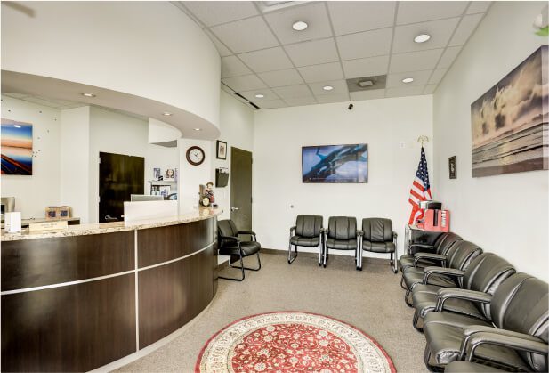 Reception area with chairs and a circular rug.